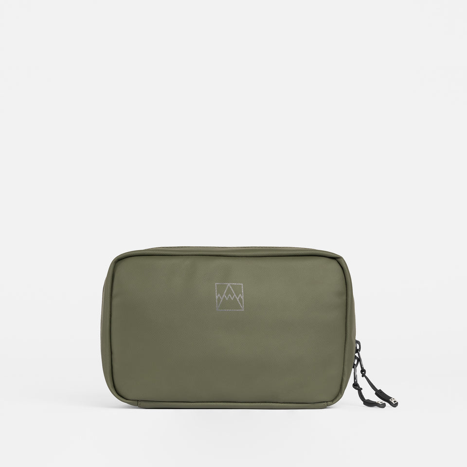 A studio shot of the front of the tech bag in urban green